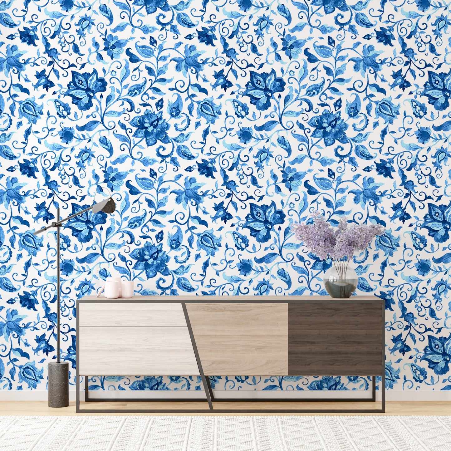 Sideboard against blue paisley floral pattern wallpaper in a bright room.
