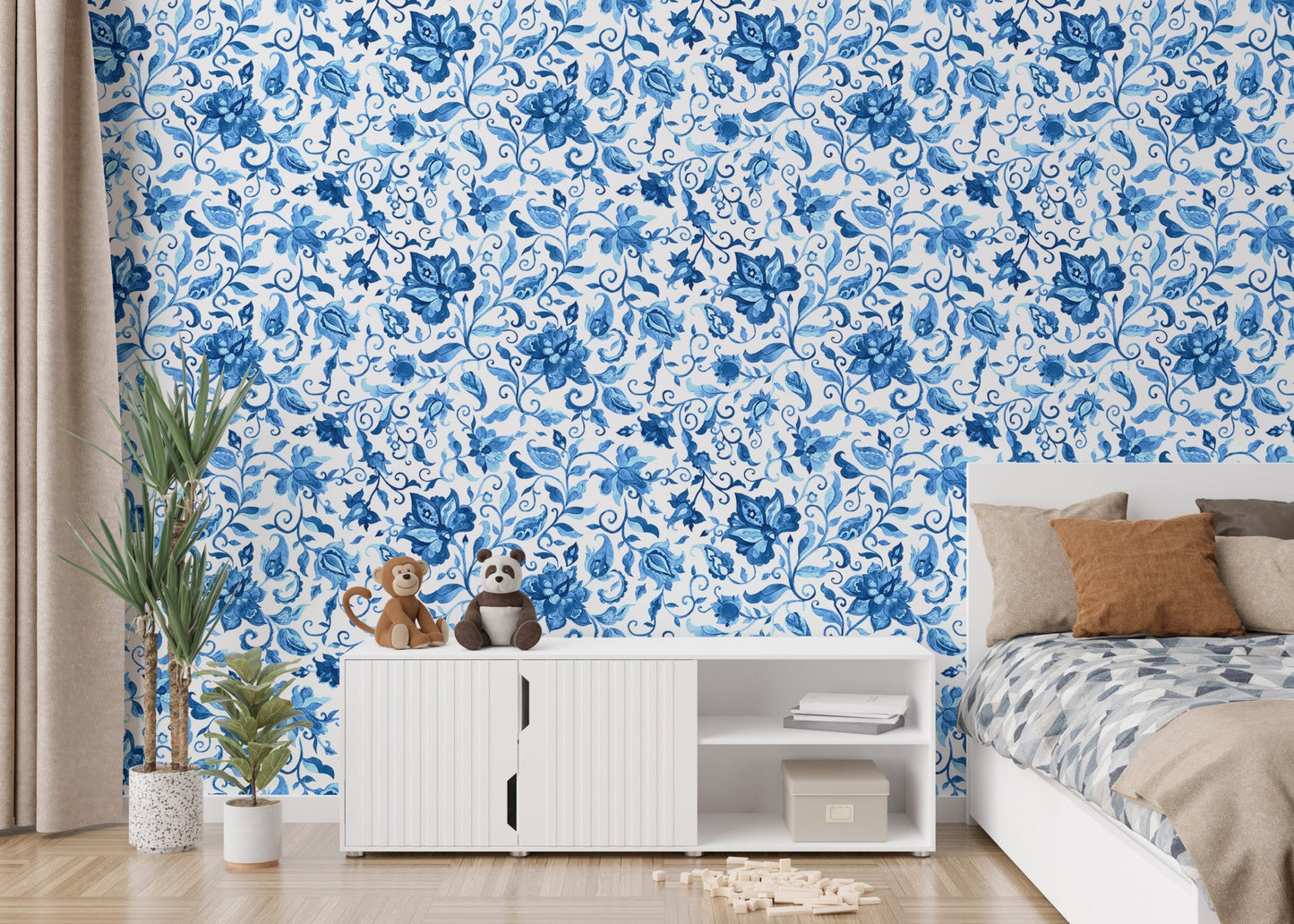 Minimalist bedroom wallpaper with blue floral designs behind white media console.