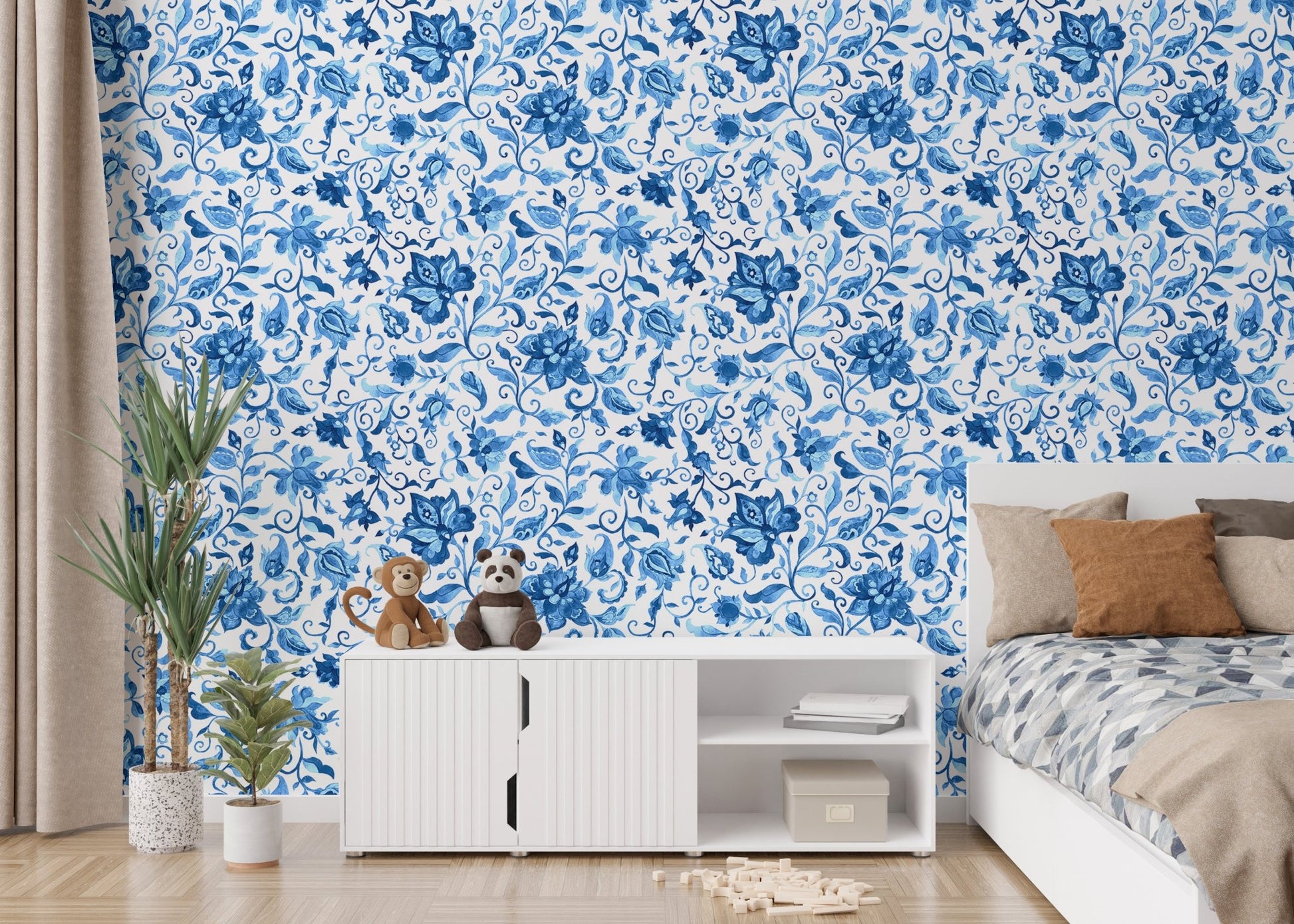 Minimalist bedroom wallpaper with blue floral designs behind white media console.