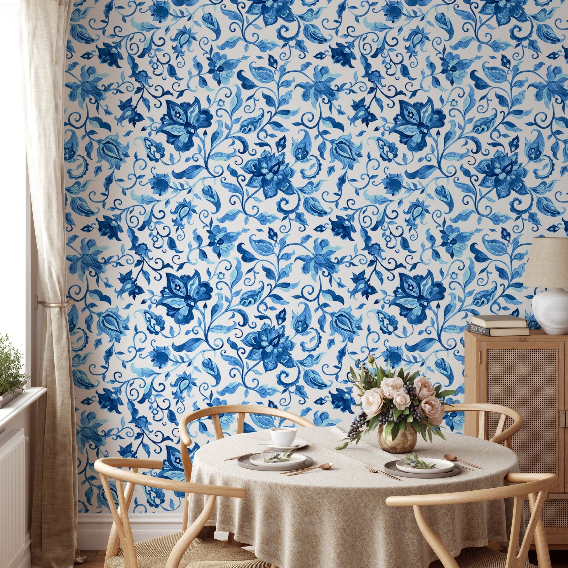 Dining room wallpaper with blue paisley floral pattern and wooden table.