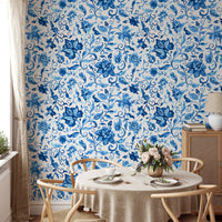 Dining room wallpaper with blue paisley floral pattern and wooden table.