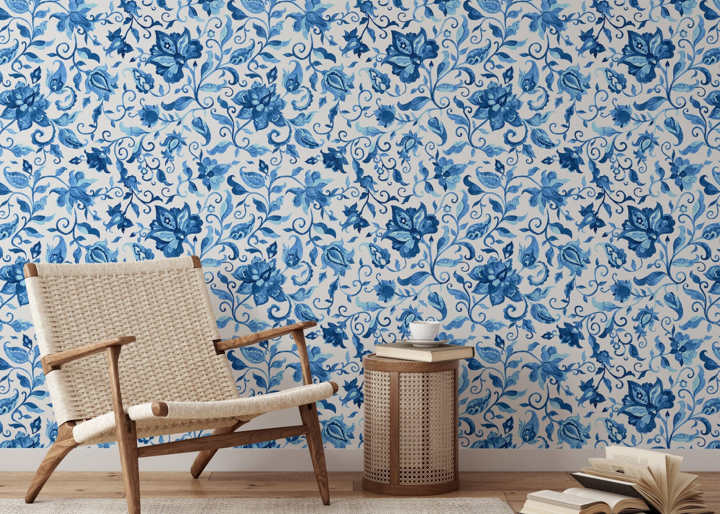 Mid-century armchair placed against blue watercolor floral wallpaper.