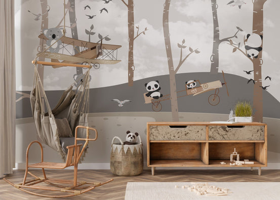 Panda Koala Aviator Explorers Wall Murals in a nursery with a wooden rocker.