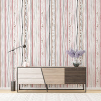 Vertical patterned wallpaper behind a modern wood console table