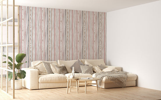 Striped pastel wallpaper behind a beige sofa in a living room.