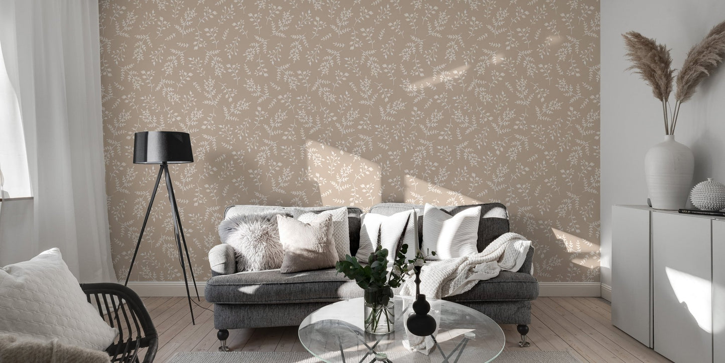 Neutral leaf wallpaper in a spacious living area with a grey sofa.