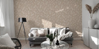 Neutral leaf wallpaper in a spacious living area with a grey sofa.