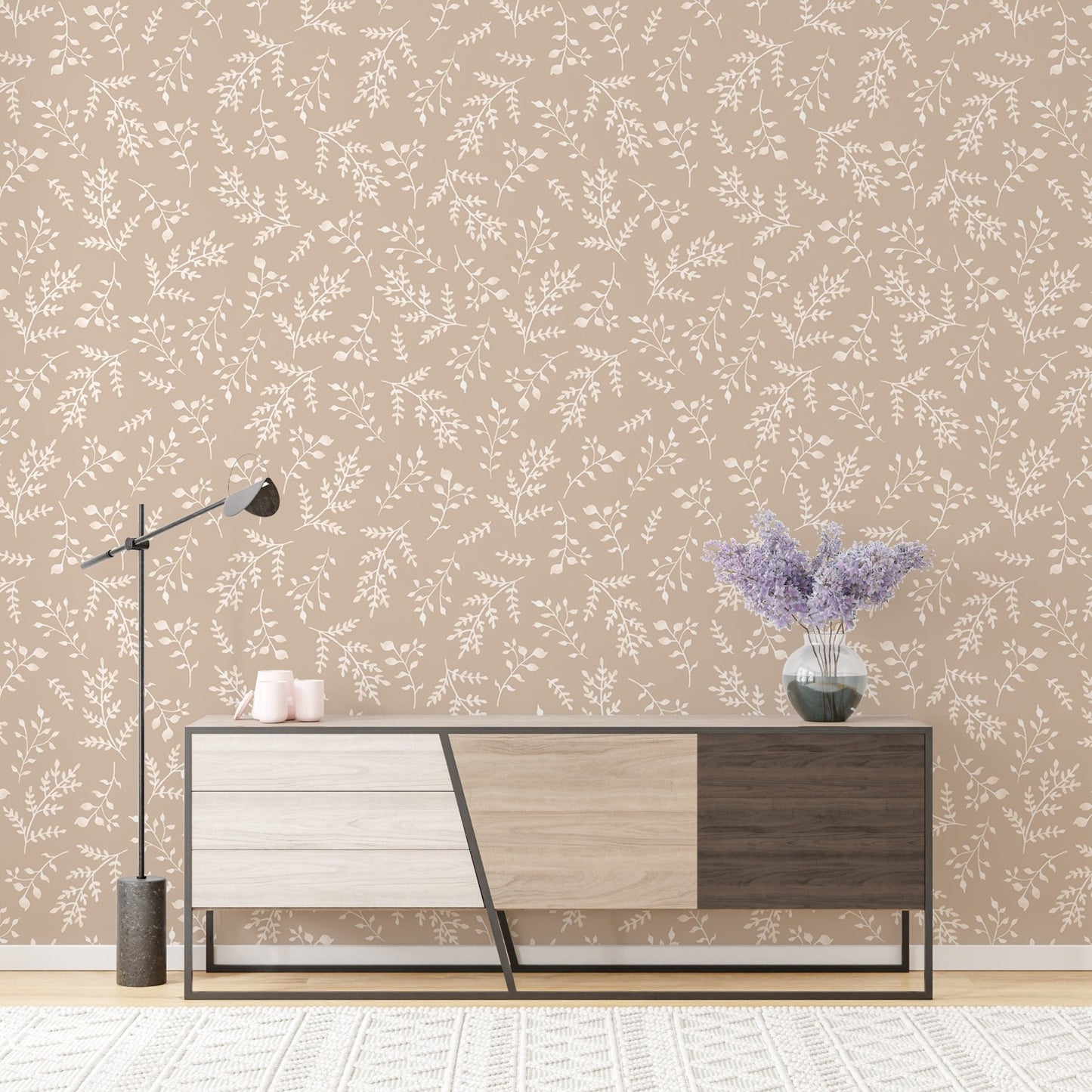 Neutral foliage wallpaper in a living room with a modern wooden sideboard.