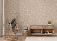 Botanical seamless wallpaper in a nursery featuring a hanging wicker chair.