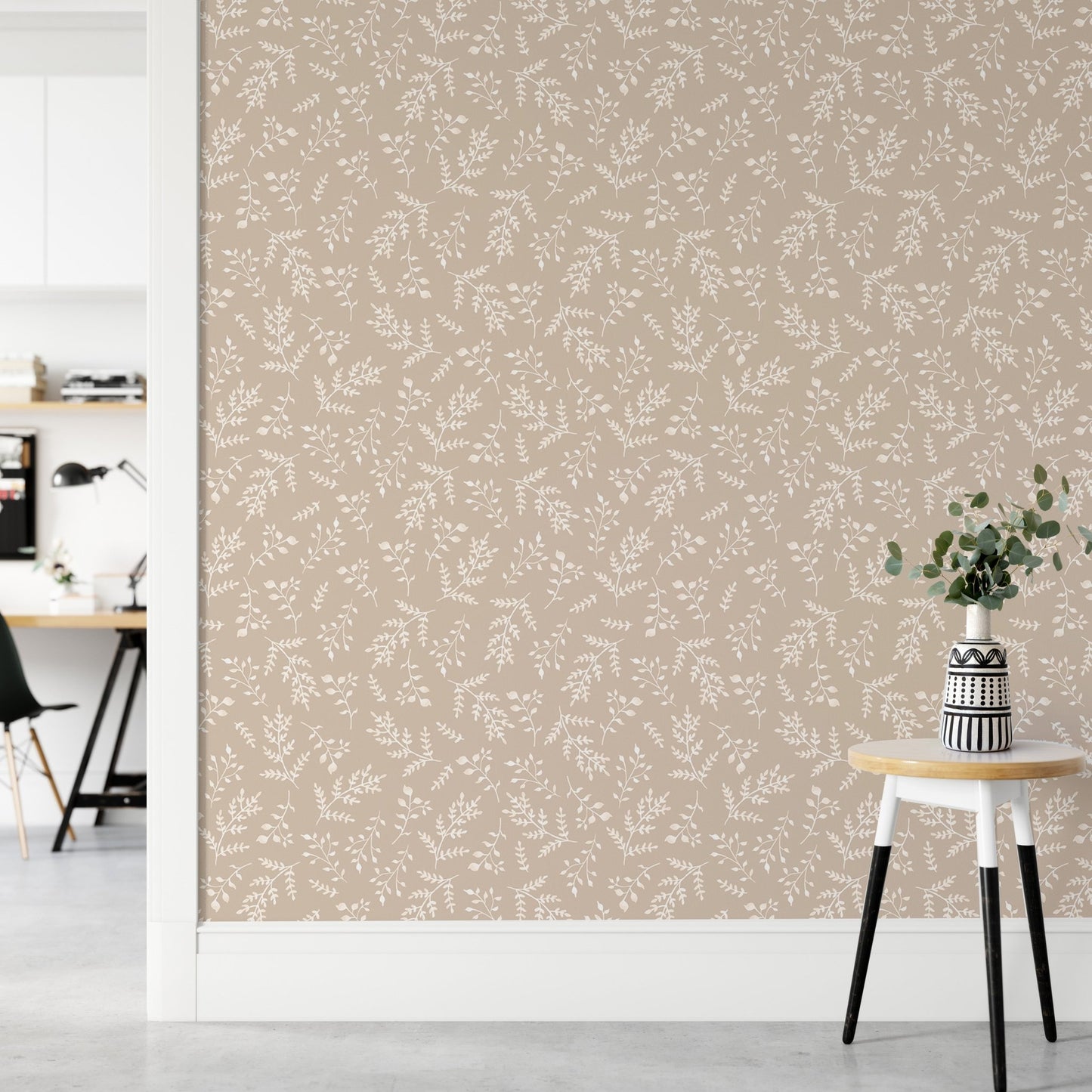 Seamless foliage wallpaper in a bright hallway with a small stool.