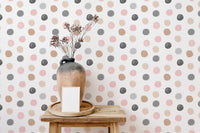Multi colored dot wallpaper in a modern room with vase and table.