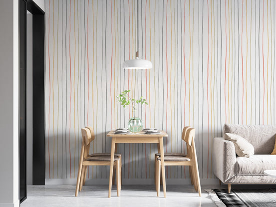 Pastel striped wallpaper behind a small wooden dining table.