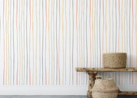 Pastel striped wallpaper behind a wooden bench and floor baskets