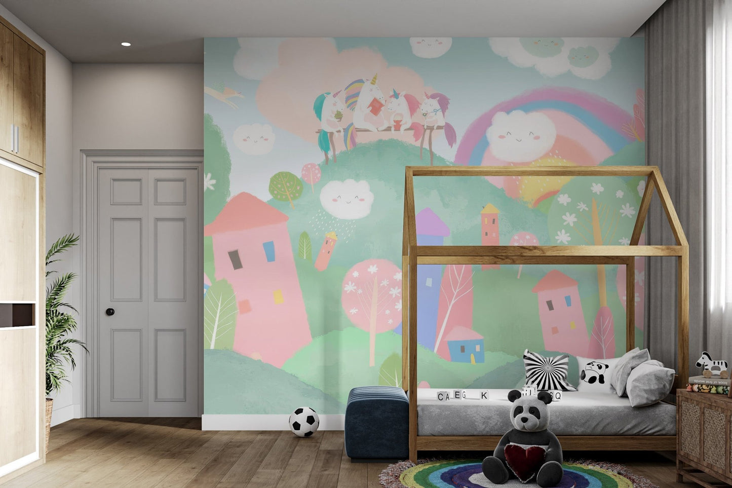 Fantasy wall mural with rainbow hills, unicorns, and smiling clouds.