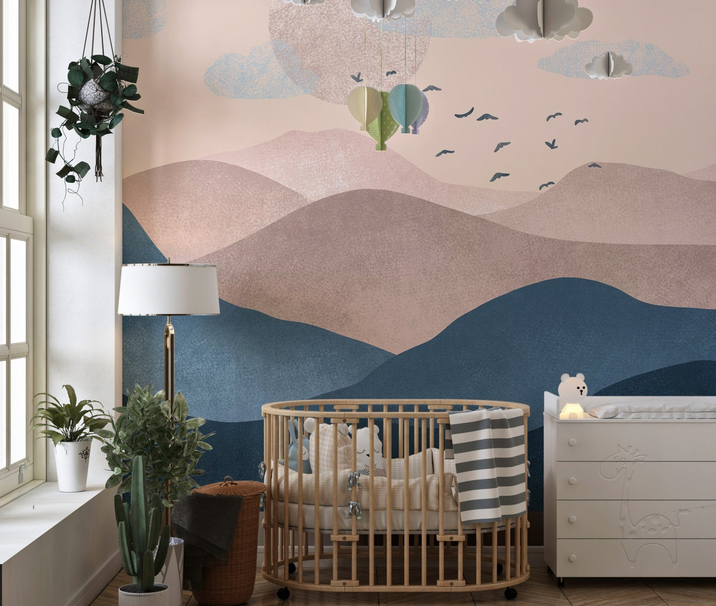 Mountain-inspired mural with dreamy pastel shades in nursery.
