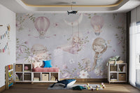 Soft pastel wall mural featuring girls, , and hot air balloon in sunlit playroom.