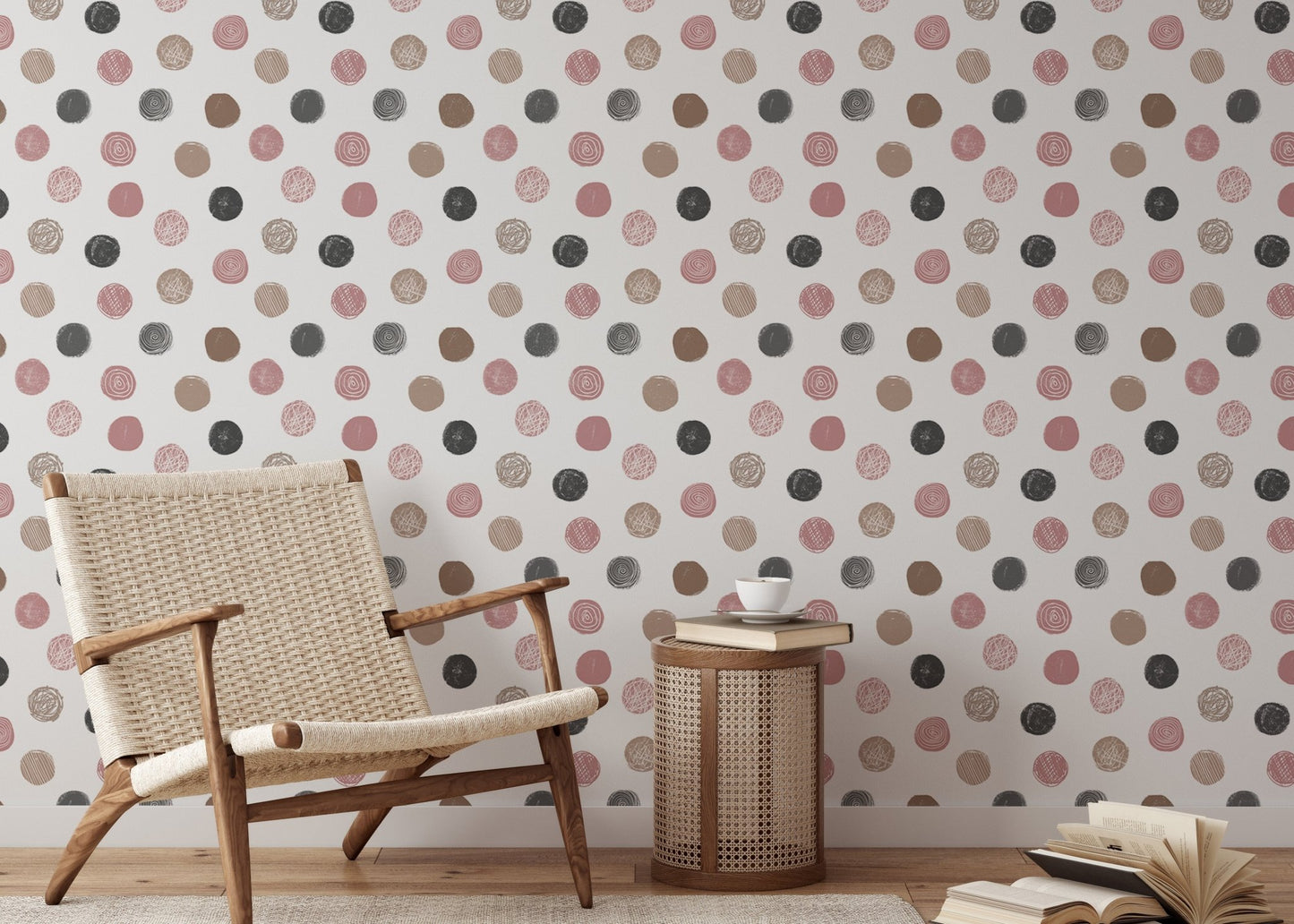 Neutral nursery featuring a polka dot wallpaper and light wood furniture.