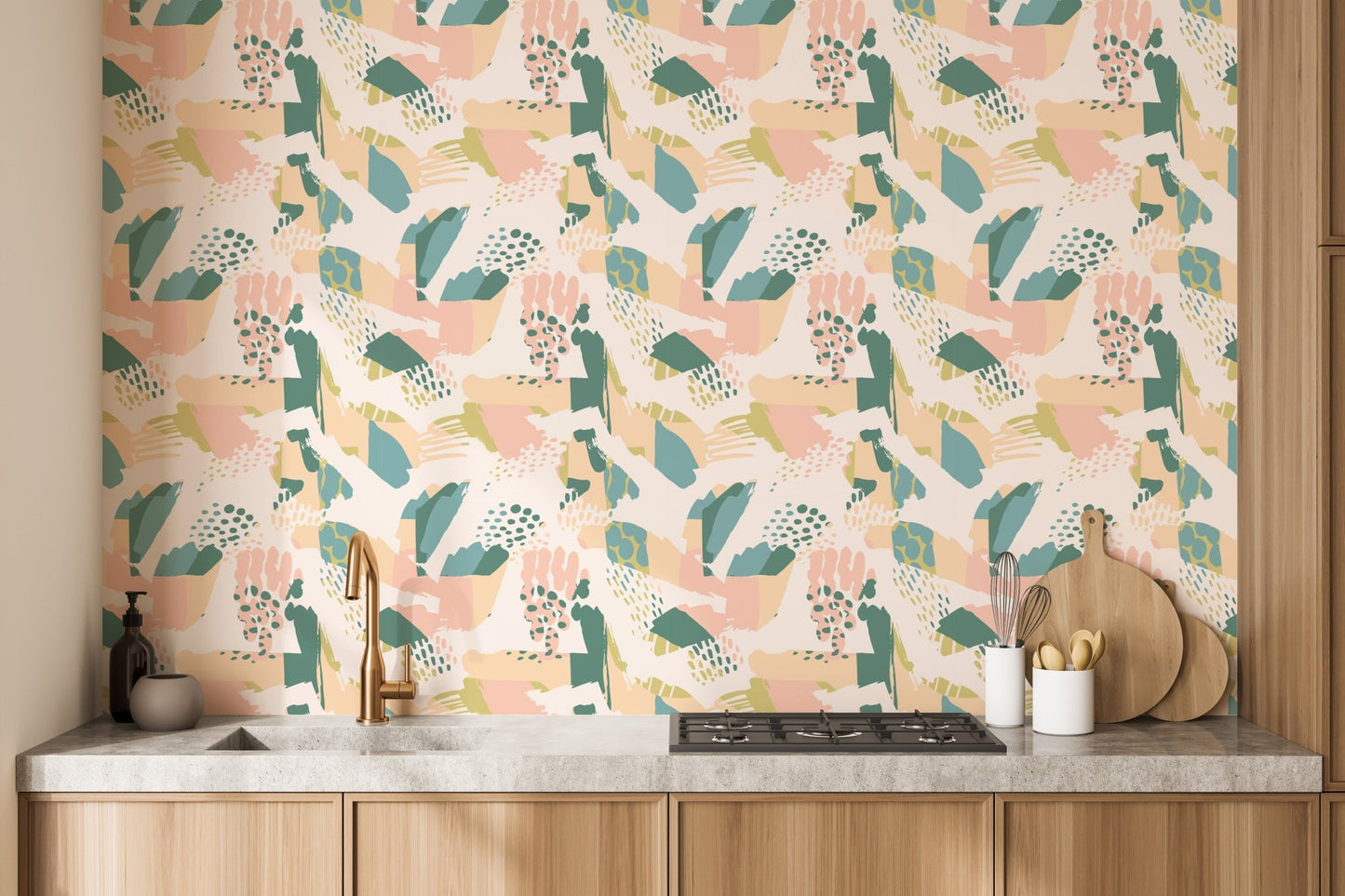 Pastel leaf and shapes wallpaper mural behind a modern kitchen counter.