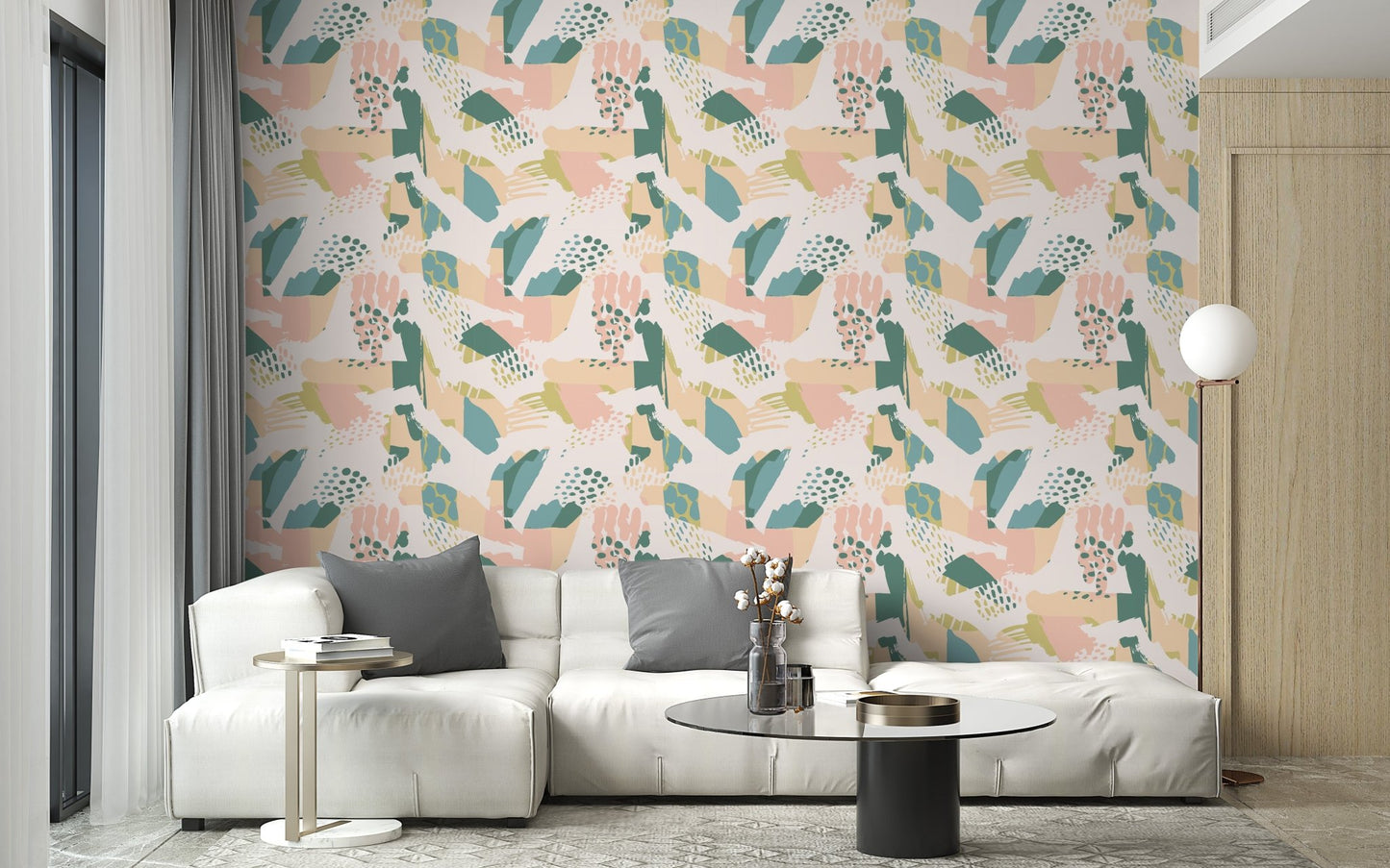 Pink and green botanical pattern wallpaper in a living room with a white sofa.