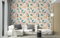Pink and green botanical pattern wallpaper in a living room with a white sofa.