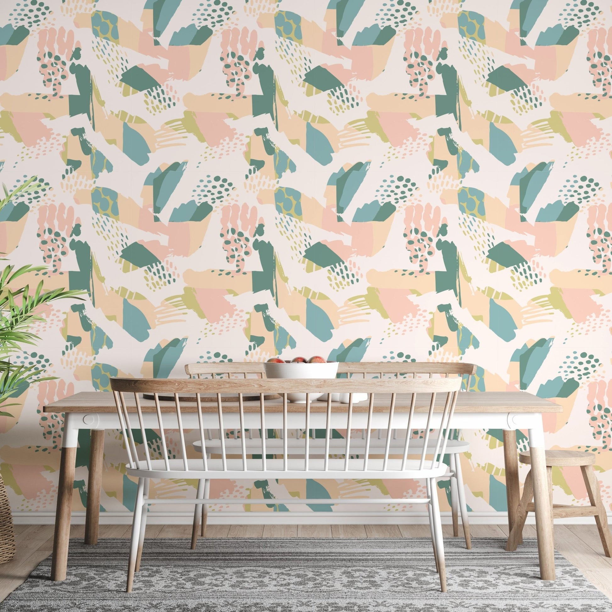 Abstract botanical pattern wallpaper in a dining area with a white table and mesh chair.