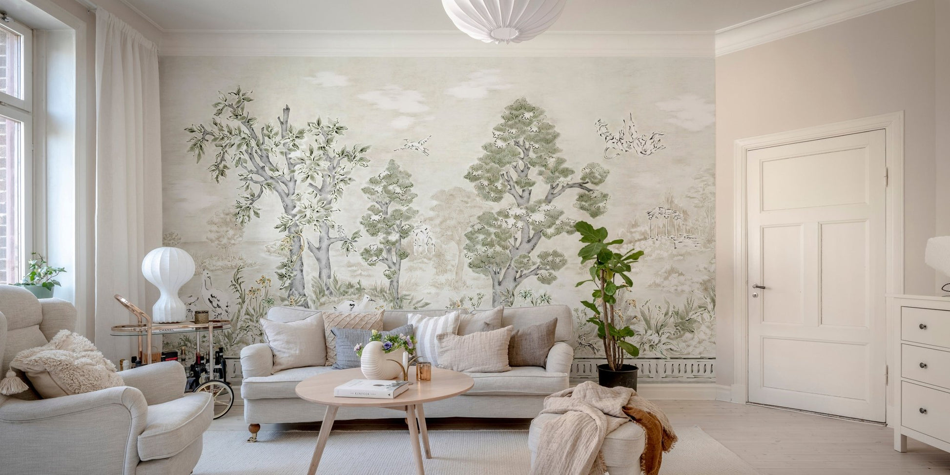 Nature themed tree wall mural with bird illustrations in a minimalist living area.