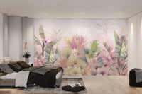 Floral and tropical leaf wall mural with a pale grey background.