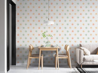 Modern dining area featuring pastel watercolor polka dots wallpaper behind a table.