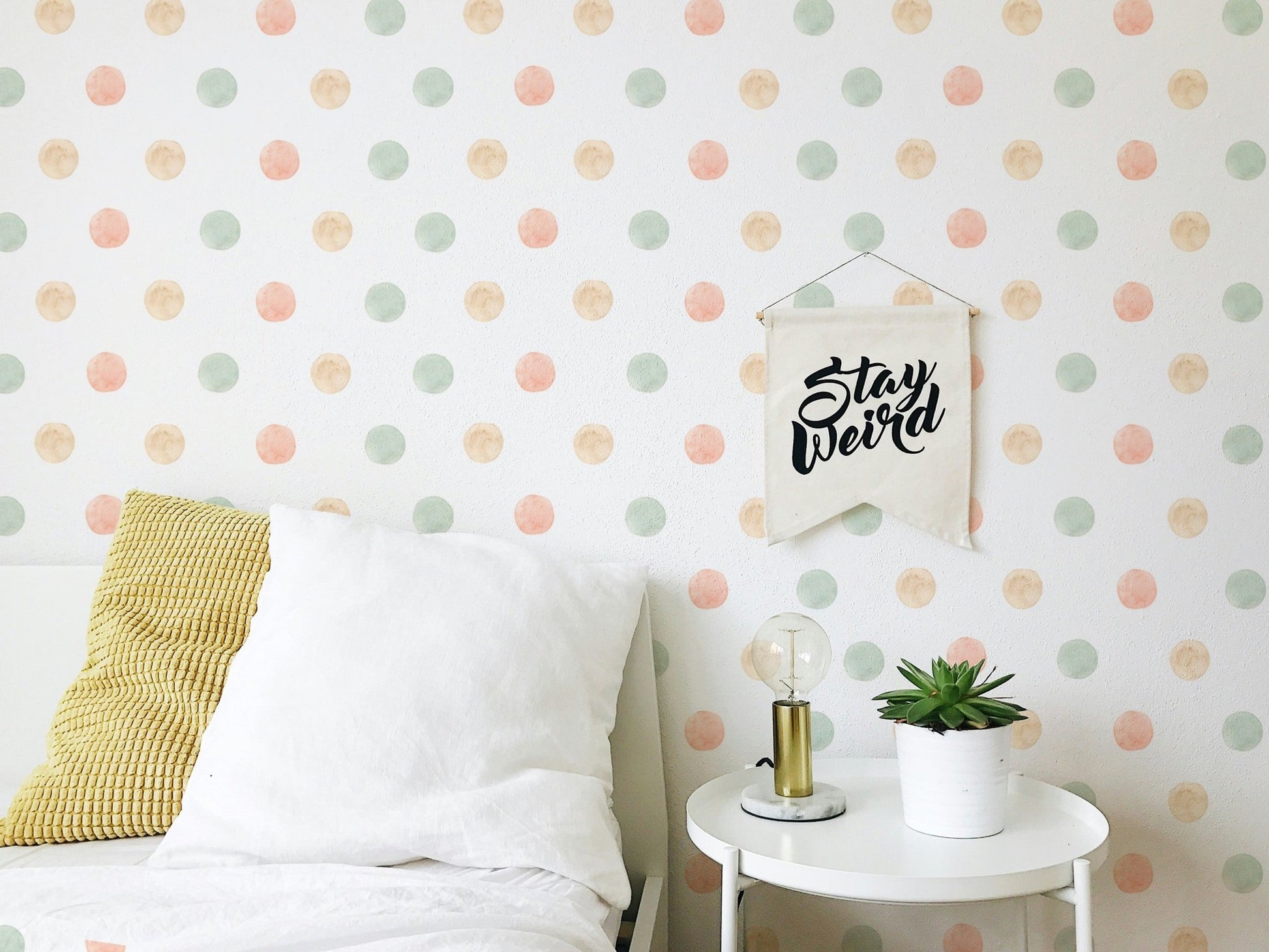 Bedroom feature wall using pastel watercolor polka dots isolated white wallpaper.