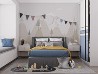 Minimalist mountain peaks wall mural in a child's bedroom with a white dresser.