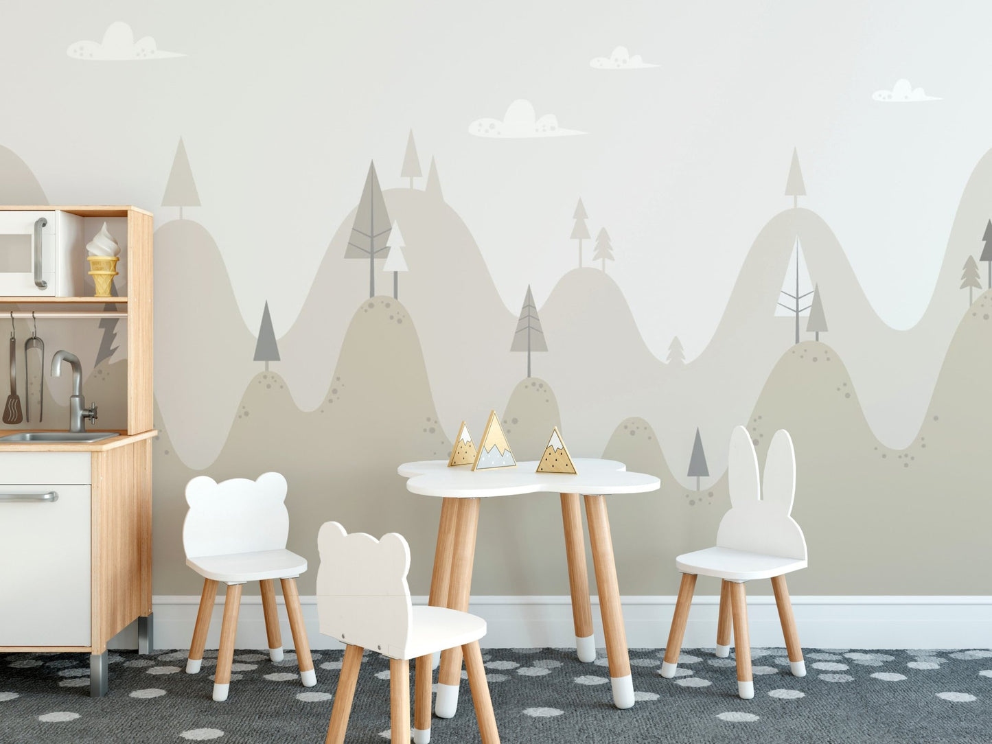 Nursery dining area wall mural showing pine trees and hills behind a white table and chairs.