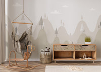 Minimalist mountain retreat wall mural near a hanging wicker chair.