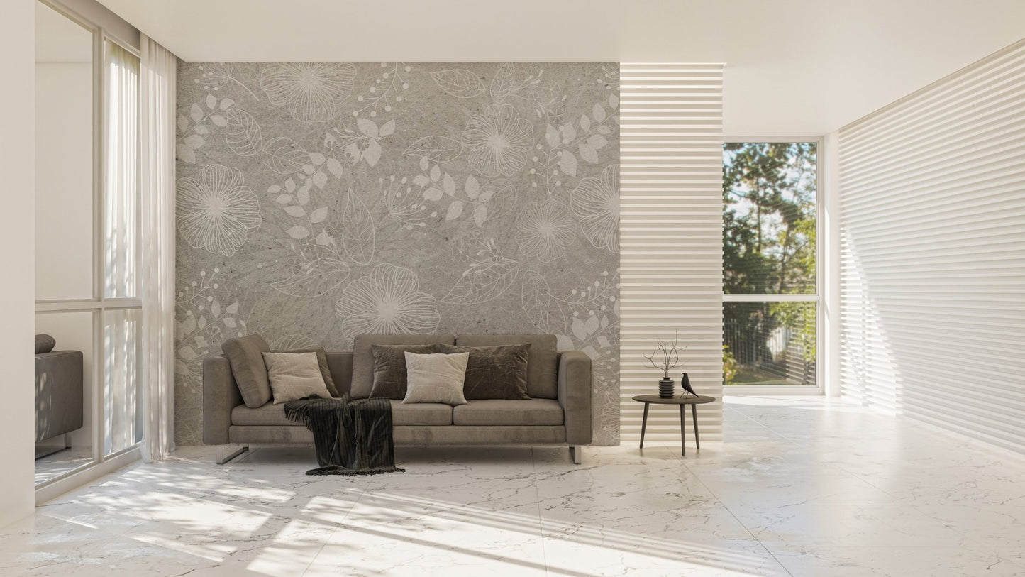 Grey flower wall mural behind a brown leather sofa in a bright living room.