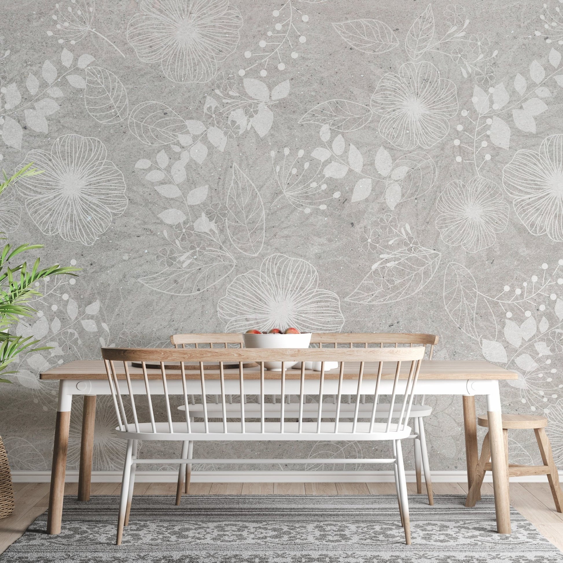 Grey and white botanical flower wall mural behind a wooden dining table and bench.
