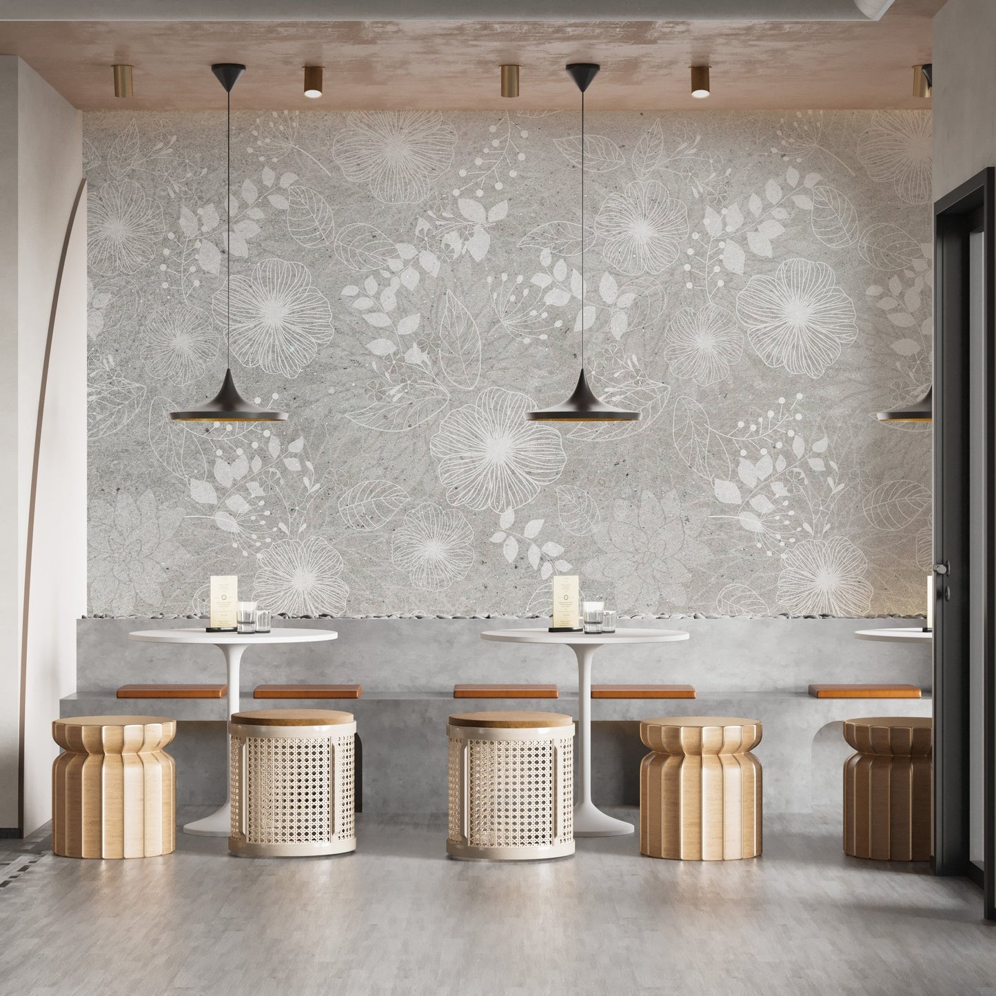 Restaurant wall mural with repetitive white flower patterns and hanging pendant lights.