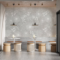 Restaurant wall mural with repetitive white flower patterns and hanging pendant lights.