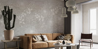Minimalist flower wall mural in a living space featuring a tan sofa and cactus plant.
