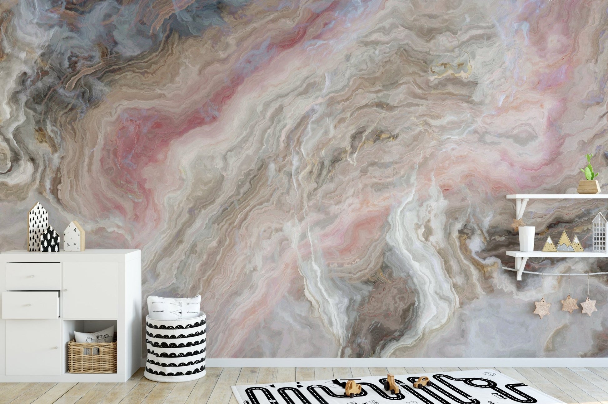 Pink and grey marble pattern wall mural behind a minimalist wooden toys.