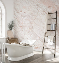 White bathtub against Oyster Pink Marble Wall Murals in a bright bathroom.