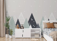 Neutral tone mountain pattern wall mural in a bedroom with a white dresser and plant.