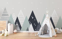 Grey and white triangle patterns wall mural behind a canvas play teepee.