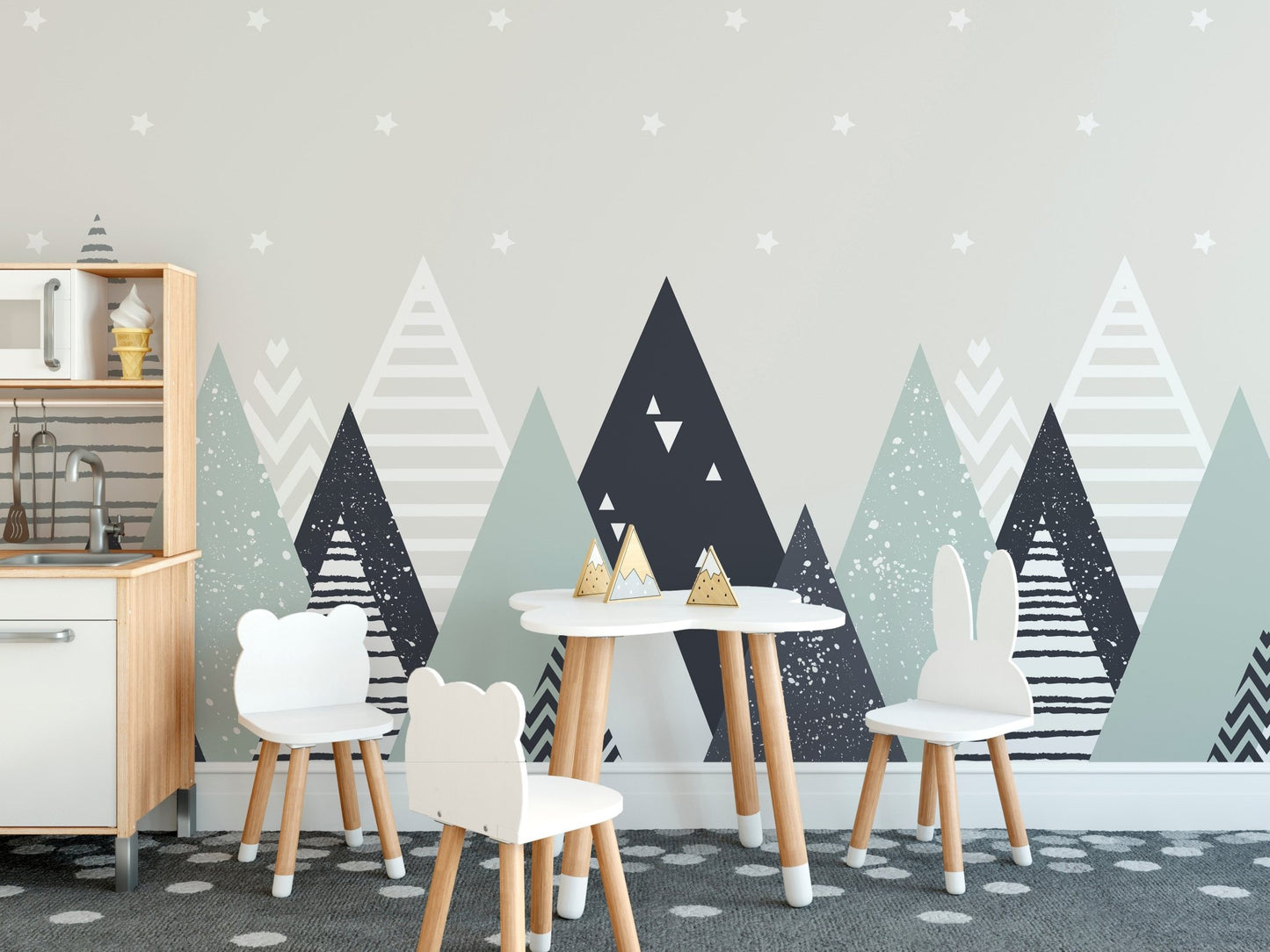 Nordic mountain wall mural in a kids play area with white table and chairs.