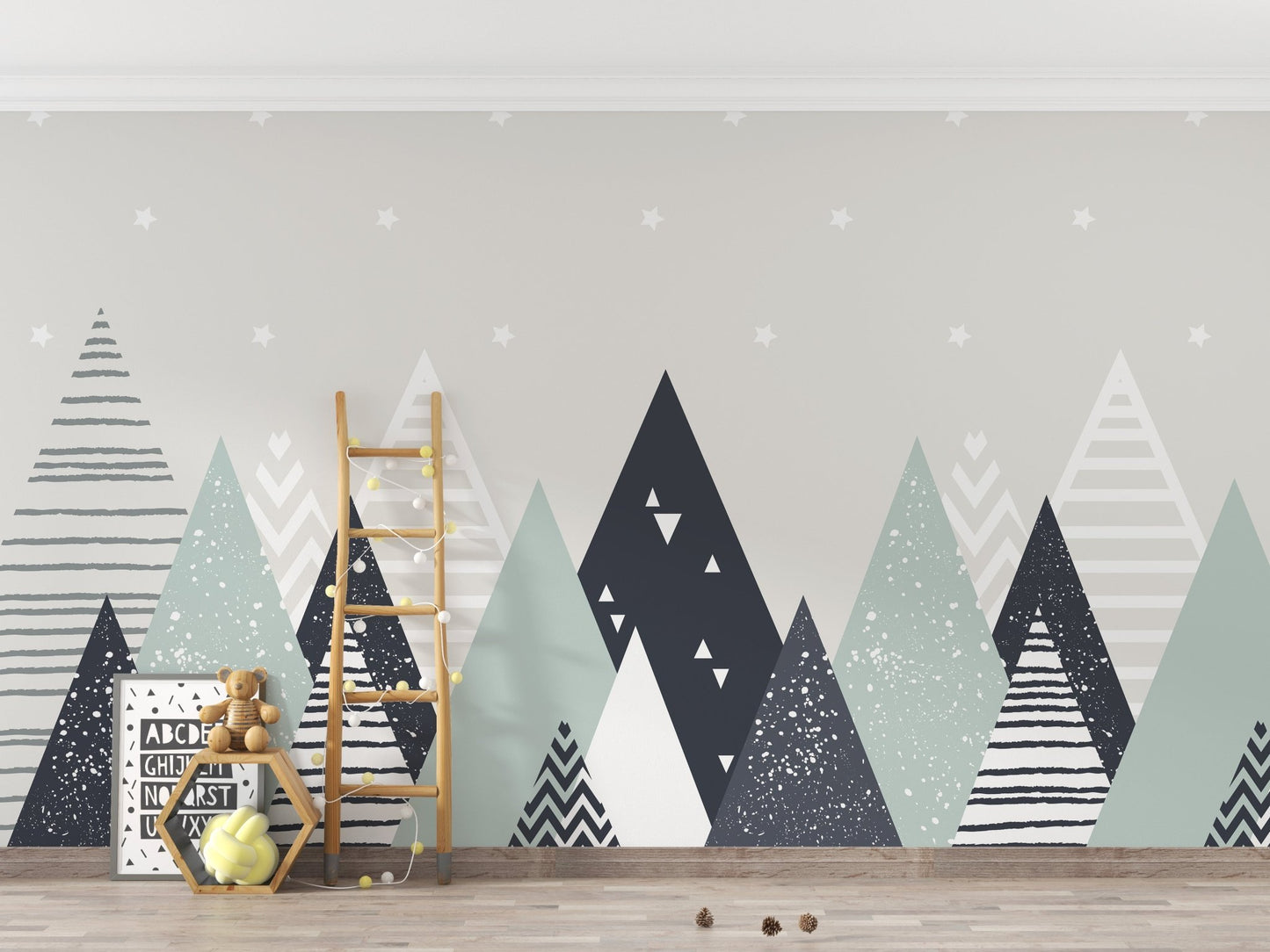 Triangle mountain wallpaper mural with a wooden ladder and toy storage.