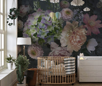Floral garden wall mural in a nursery with a wooden crib and indoor plants.