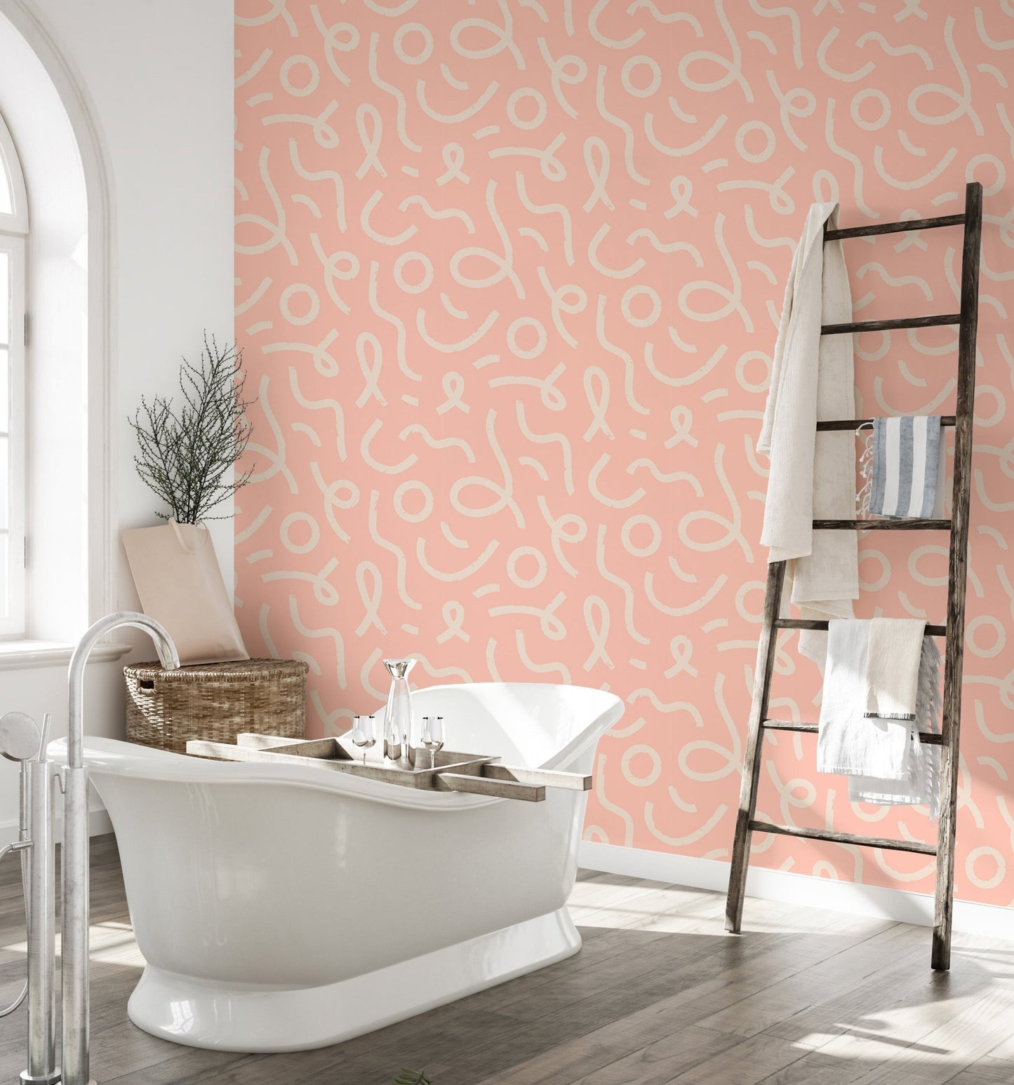Modern abstract wallpaper in a bathroom with a white freestanding tub and wooden ladder.