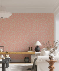 Minimal line brush stroke wallpaper behind a wooden desk and white sofa.
