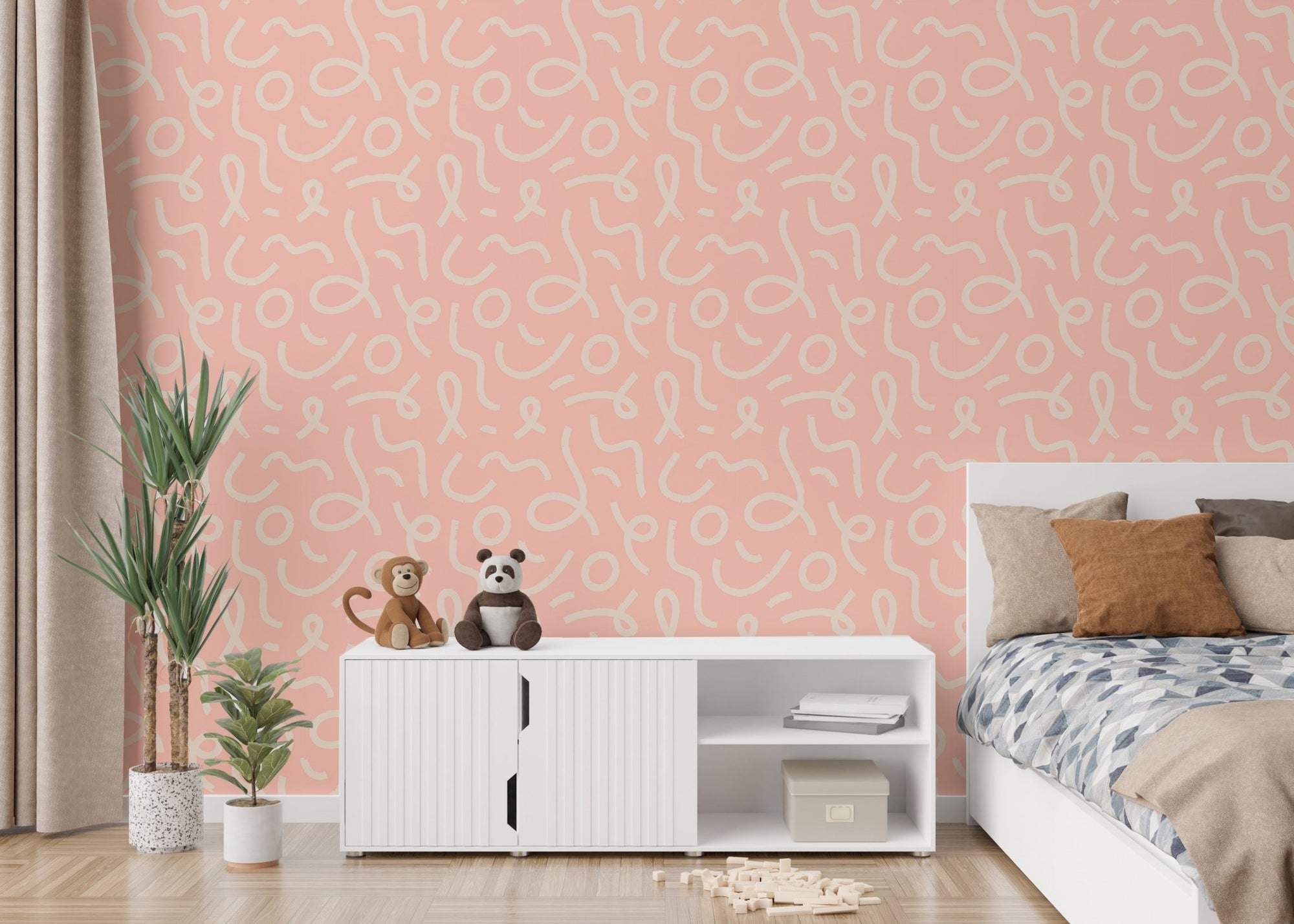Pink abstract wallpaper in a bedroom with a white sideboard and stuffed toys.