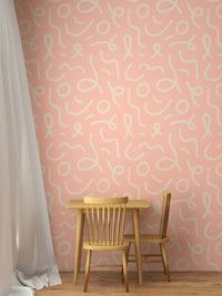 Pink abstract minimal line brush stroke wallpaper behind a small dining set.