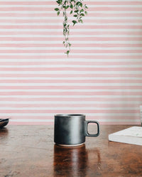Pink Color Abstract Stripe Watercolor Wallpaper behind a wooden table.