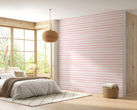 Soft pink watercolor wallpaper in a bedroom with natural light.